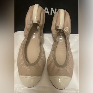 Chanel nude ballerinas with white patent leather accents.